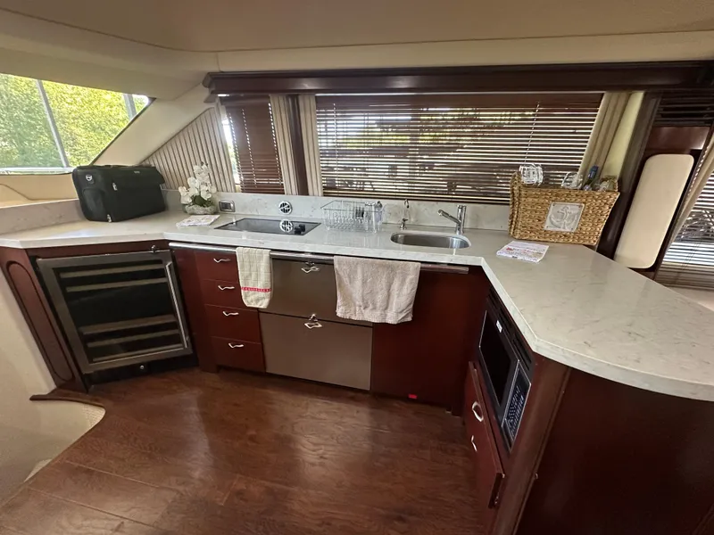 Slide: The Image of Luxurious kitchen interior of 2006 Sea Ray 58 Sedan Bridge yacht with modern appliances. - 12