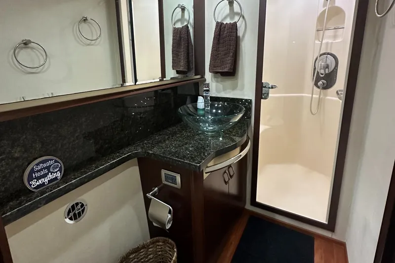 Slide: The Image of Luxurious bathroom in 2006 Sea Ray 58 Sedan Bridge yacht with glass sink and shower. - 14