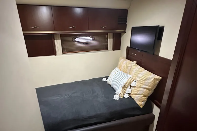 Slide: The Image of Luxurious cabin interior of 2006 Sea Ray 58 Sedan Bridge yacht with cozy bed and TV. - 16