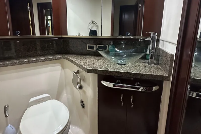 Slide: The Image of Luxurious bathroom in 2006 Sea Ray 58 Sedan Bridge yacht with modern fixtures and granite countertop. - 17