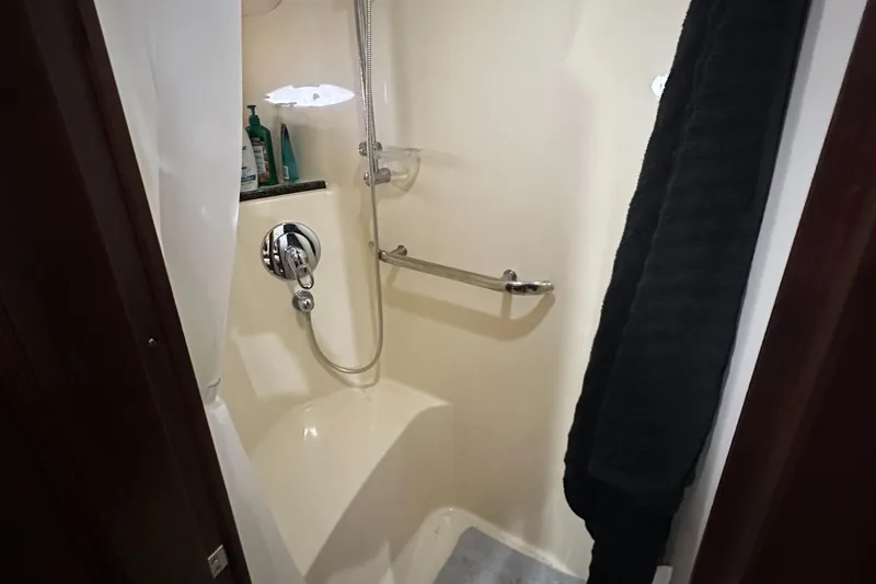 Slide: The Image of Shower area in 2006 Sea Ray 58 Sedan Bridge yacht, featuring modern fixtures and storage. - 18
