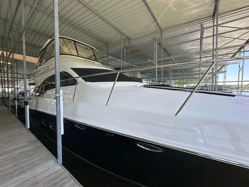 Slide: The Image of 2006 Sea Ray 58 Sedan Bridge yacht docked under a covered marina. - 5