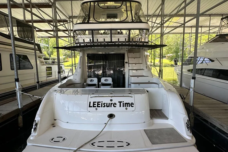 Slide: The Image of 2006 Sea Ray 58 Sedan Bridge yacht docked, named "LEEsure Time," rear view. - 7