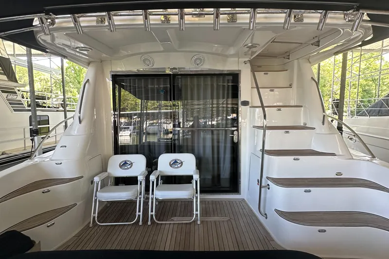 Slide: The Image of 2006 Sea Ray 58 Sedan Bridge yacht deck with chairs and staircase. - 8