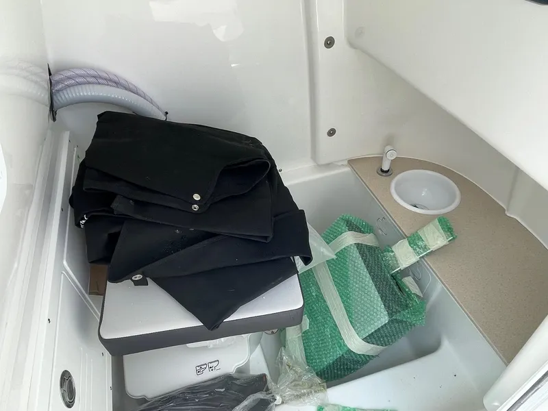 Slide: The Image of Interior of 2025 Sea Pro 245 Sandbar boat with storage and sink area. - 13