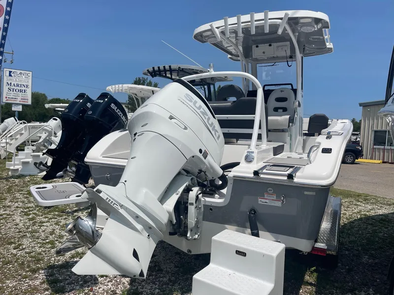 Slide: The Image of 2025 Sea Pro 245 Sandbar boat with dual outboard motors, displayed at a marine store. - 3