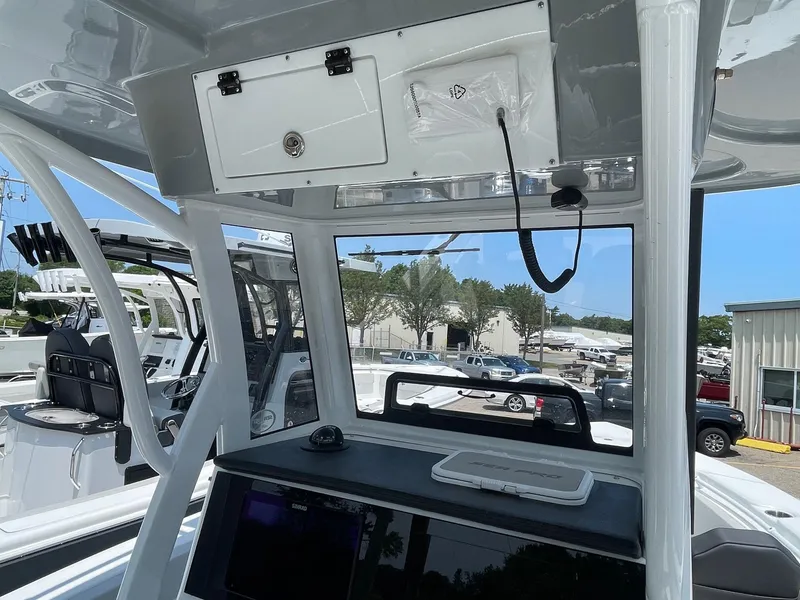 Slide: The Image of 2025 Sea Pro 245 Sandbar boat interior with console and storage compartments. - 5