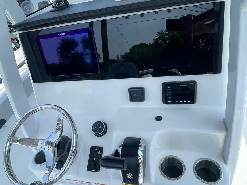 Slide: The Image of 2025 Sea Pro 245 Sandbar boat dashboard with steering wheel, controls, and electronic display. - 6
