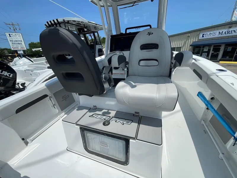 Slide: The Image of 2025 Sea Pro 245 Sandbar boat interior with seating and console, showcasing modern design. - 8