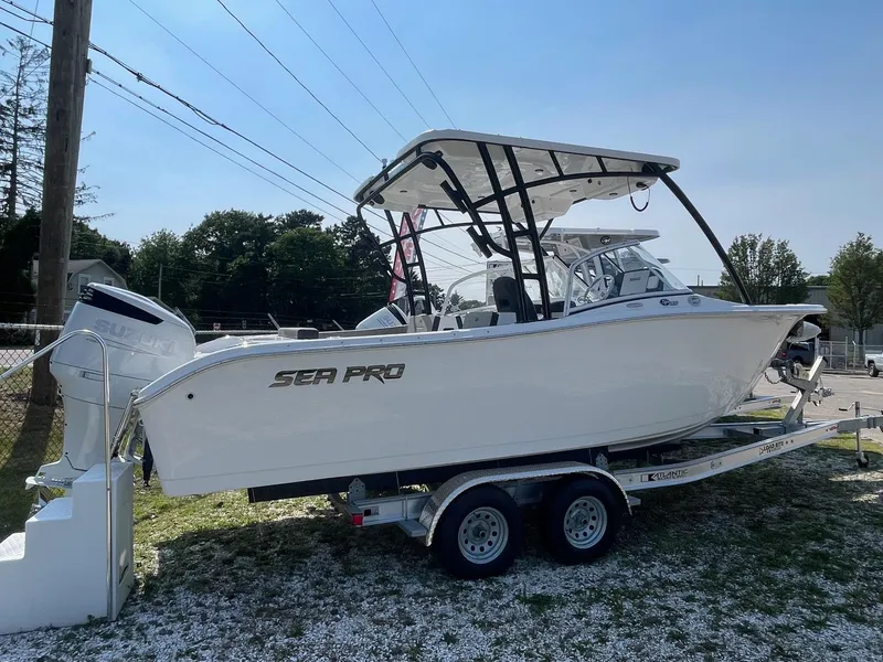 Slide: The Image of 2025 Sea Pro 240 Dual Console boat on trailer, parked outdoors. - 0