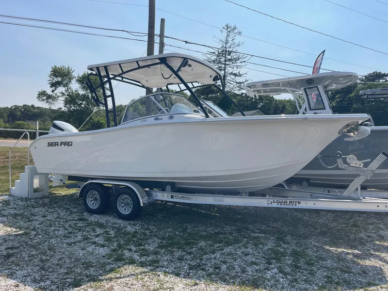 Slide: The Image of 2025 Sea Pro 240 Dual Console boat on trailer, displayed outdoors. - 1