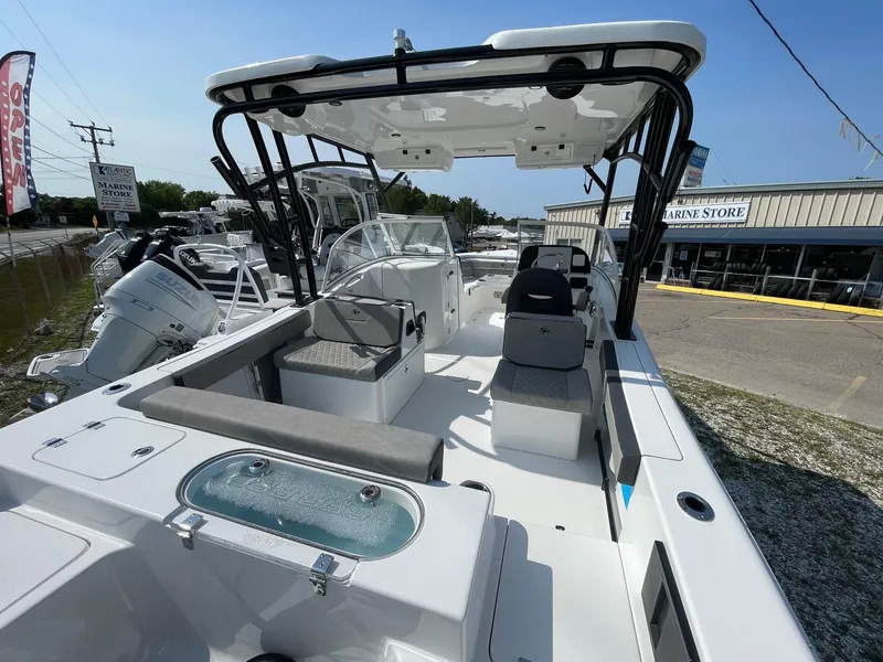 Slide: The Image of 2025 Sea Pro 240 Dual Console boat with seating and storage, displayed at a marine store. - 10