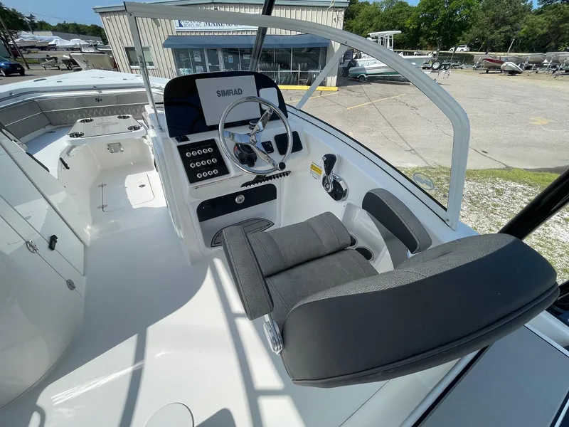 Slide: The Image of 2025 Sea Pro 240 Dual Console boat interior with steering wheel and seating. - 12