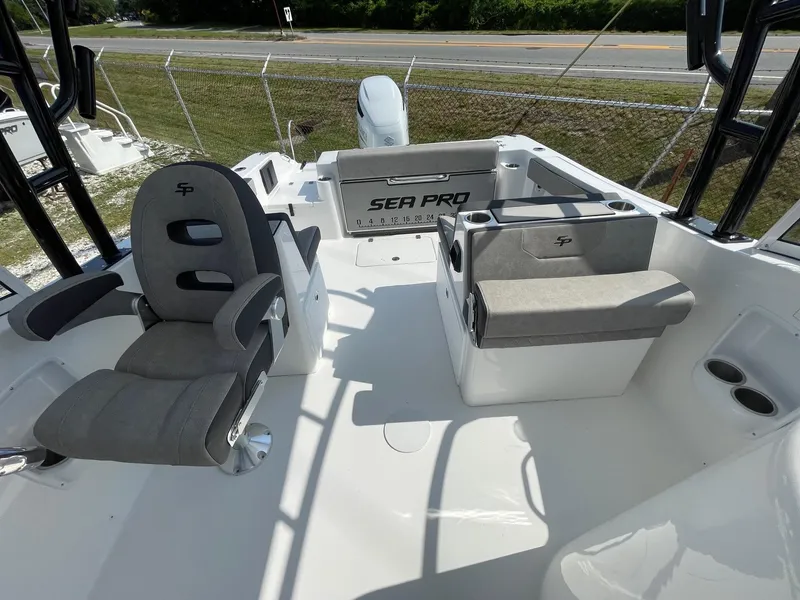 Slide: The Image of 2025 Sea Pro 240 Dual Console boat interior with seating and helm. - 16