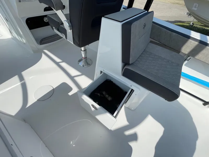 Slide: The Image of 2025 Sea Pro 240 Dual Console boat interior with open storage compartment. - 18
