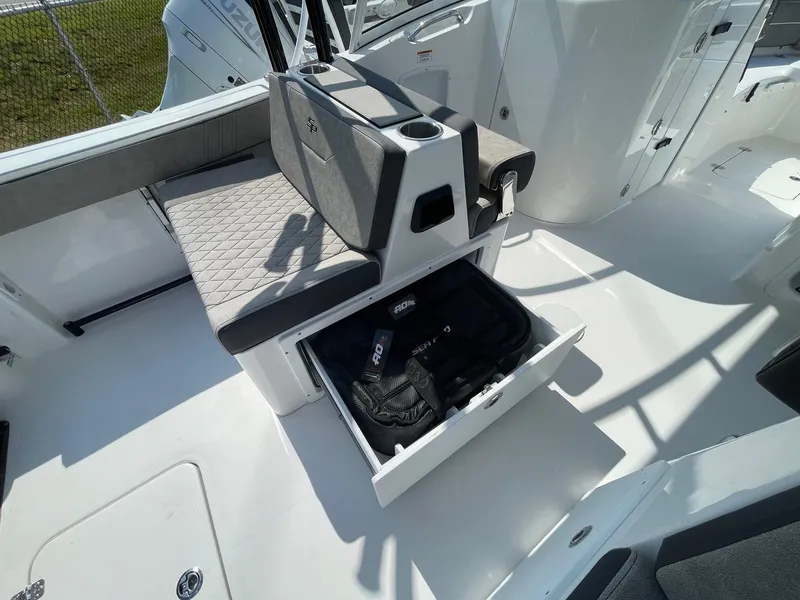 Slide: The Image of 2025 Sea Pro 240 Dual Console boat interior with storage drawer open. - 19