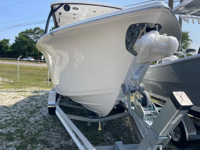 Slide: The Image of 2025 Sea Pro 240 Dual Console boat on trailer, side view, outdoors. - 2