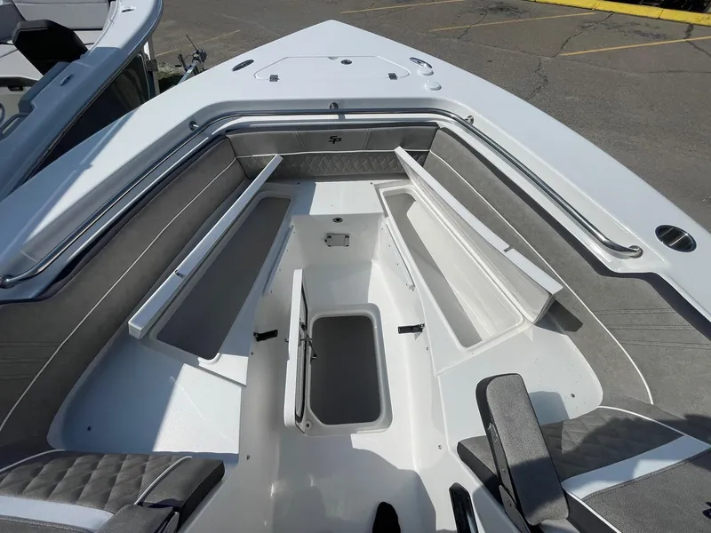 Slide: The Image of 2025 Sea Pro 240 Dual Console boat interior with open storage compartments. - 21