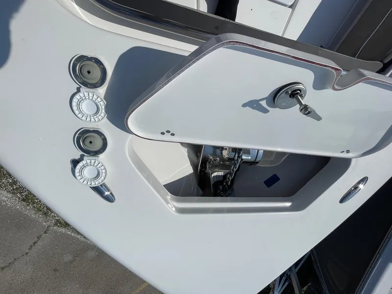Slide: The Image of 2025 Sea Pro 240 Dual Console boat with open storage compartment and control panel. - 22