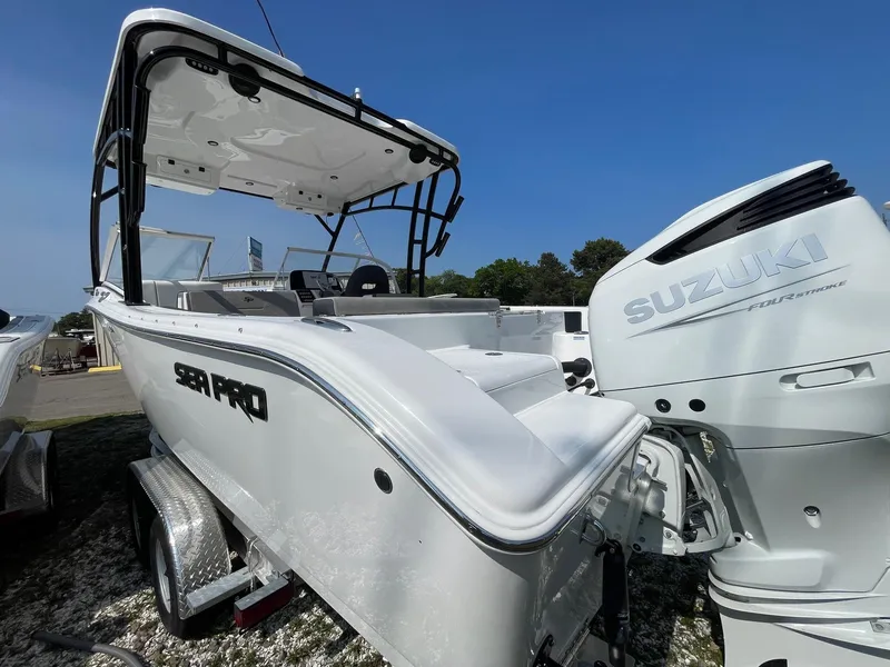 Slide: The Image of 2025 Sea Pro 240 Dual Console boat with Suzuki engine, displayed outdoors. - 4