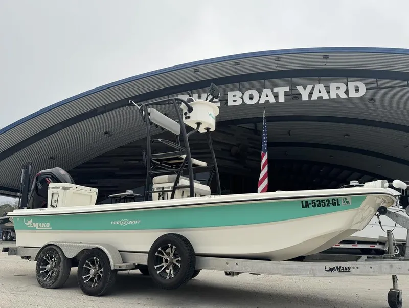 Slide: The Image of 2018 Mako Pro Skiff 19 CC Top Drive boat on trailer at boat yard. - 3