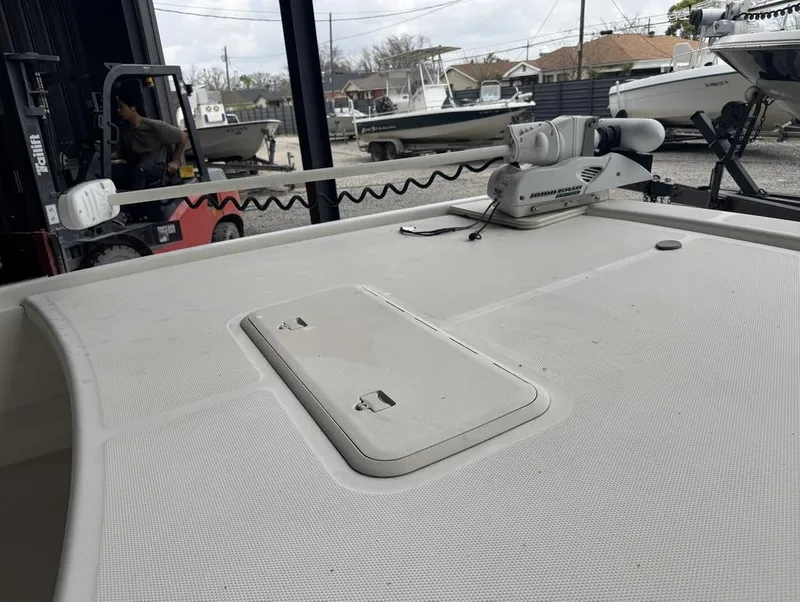 Slide: The Image of 2018 Mako Pro Skiff 19 CC Top Drive boat deck with trolling motor in storage area. - 7