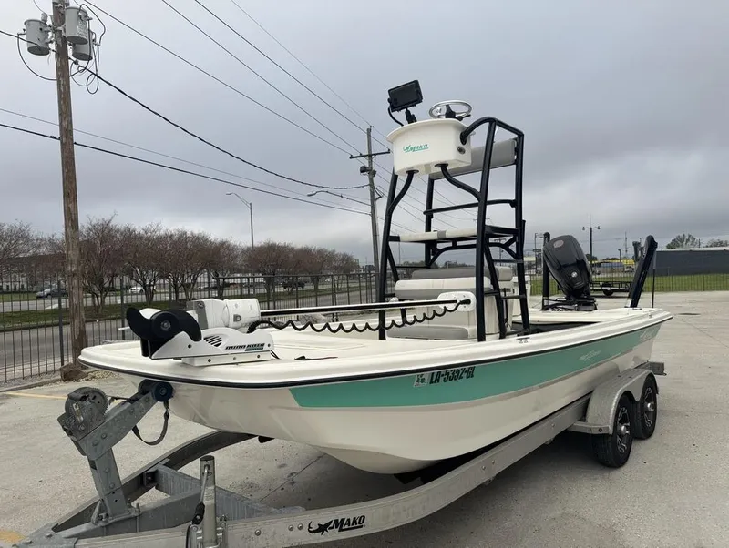 Slide: The Image of 2018 Mako Pro Skiff 19 CC Top Drive boat on trailer, overcast sky. - 9