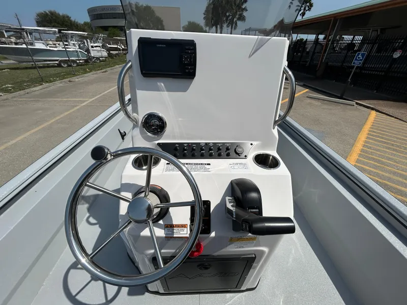 Slide: The Image of Avid 20 ROGUE CC 2025 boat console with steering wheel and controls. - 12