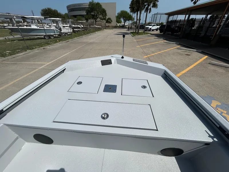 Slide: The Image of 2025 Avid 20 ROGUE CC boat deck, parked outdoors, showcasing storage compartments. - 14