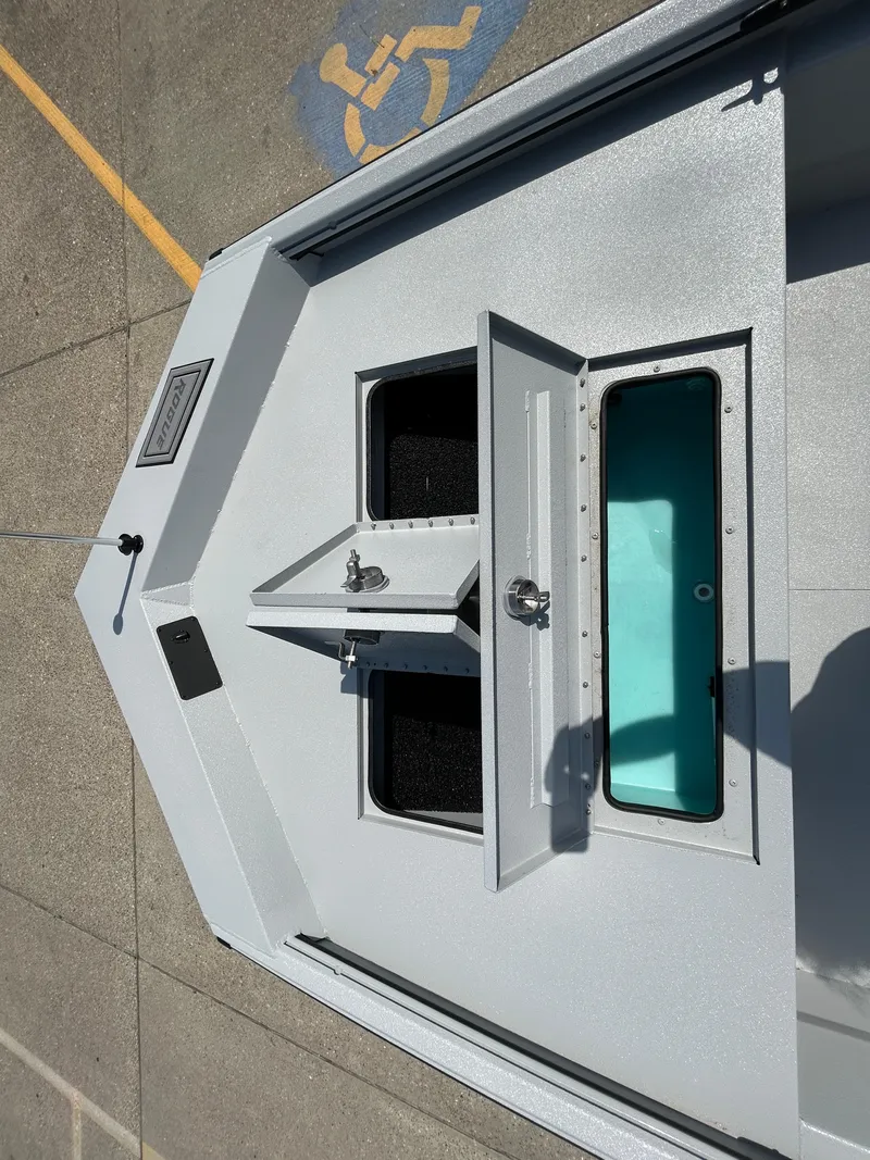 Slide: The Image of 2025 Avid 20 ROGUE CC boat deck with open storage compartments. - 15