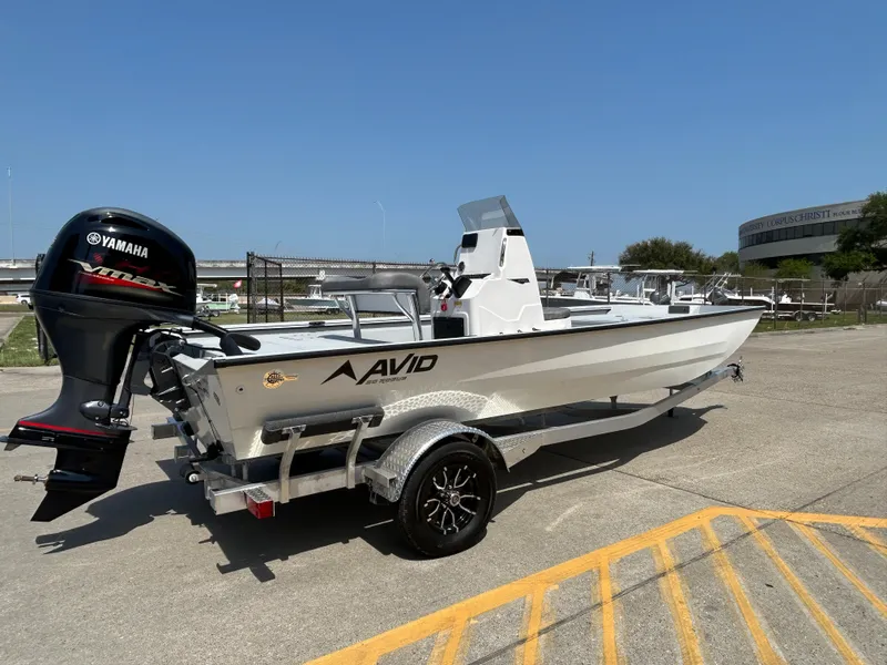 Slide: The Image of 2025 Avid 20 ROGUE CC boat with Yamaha motor on trailer, parked outdoors. - 6