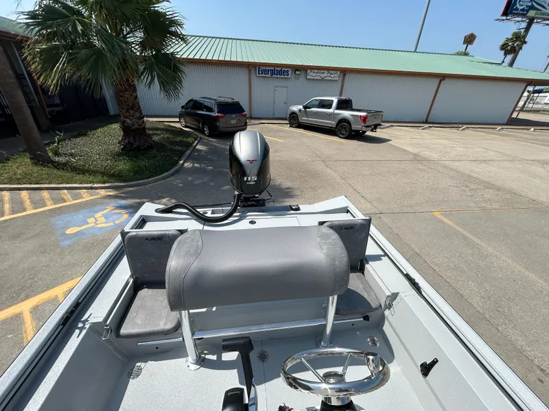 Slide: The Image of 2025 Avid 20 ROGUE CC boat with motor, parked near a building and palm tree. - 9