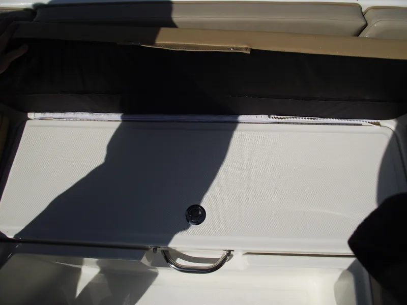 Slide: The Image of 2025 Bayliner Trophy T22SC storage compartment with handle, partially open, showing interior space. - 11