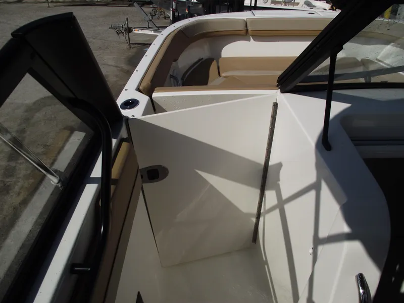 Slide: The Image of 2025 Bayliner Trophy T22SC boat interior with seating and open door. - 16