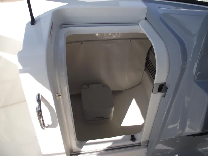 Slide: The Image of 2025 Bayliner Trophy T22SC boat storage compartment with portable toilet. - 19