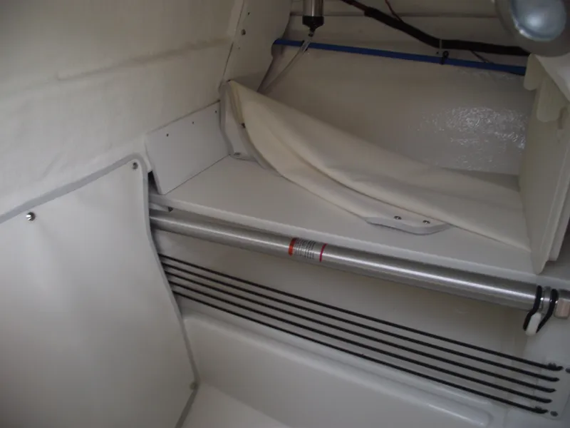 Slide: The Image of Interior view of 2025 Bayliner Trophy T22SC boat cabin, featuring storage space and sleek design. - 20