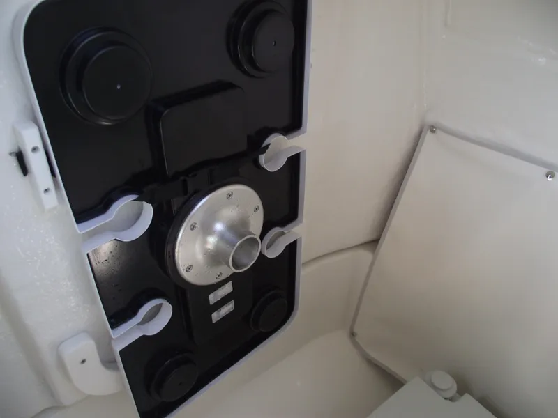 Slide: The Image of 2025 Bayliner Trophy T22SC boat interior detail, featuring a control panel and storage compartment. - 21