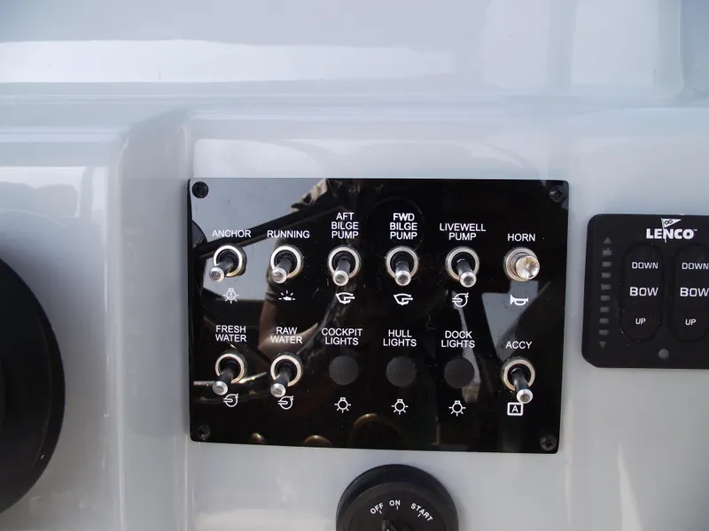 Slide: The Image of Control panel of 2025 Bayliner Trophy T22SC boat with various switches and indicators. - 24
