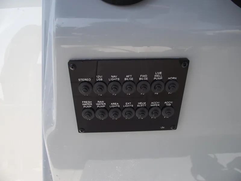 Slide: The Image of Control panel of 2025 Bayliner Trophy T22SC boat with labeled switches. - 25