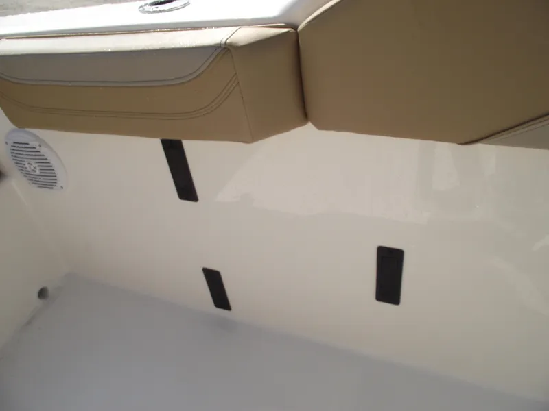 Slide: The Image of 2025 Bayliner Trophy T22SC boat interior with beige seating and speaker. - 27