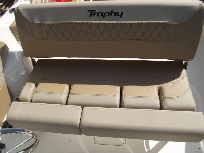 Slide: The Image of 2025 Bayliner Trophy T22SC boat seat with beige upholstery and "Trophy" logo. - 30