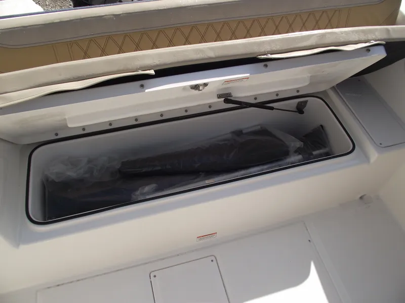 Slide: The Image of 2025 Bayliner Trophy T22SC boat storage compartment with cushioned seating. - 33