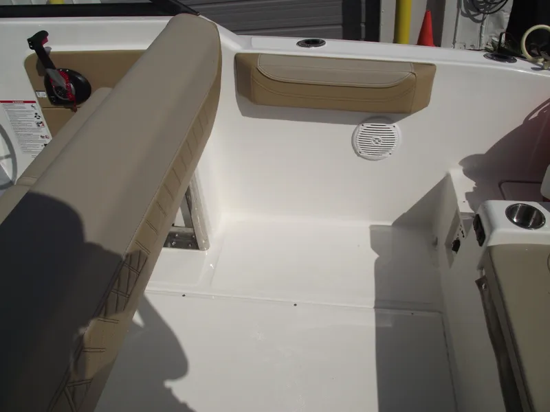 Slide: The Image of 2025 Bayliner Trophy T22SC boat interior with beige seating and cup holders. - 36