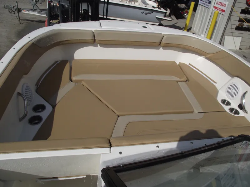 Slide: The Image of 2025 Bayliner Trophy T22SC boat interior with tan seating and cup holders. - 6