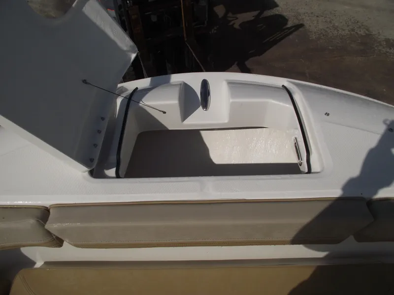 Slide: The Image of 2025 Bayliner Trophy T22SC boat storage compartment with open hatch, showcasing interior space. - 8