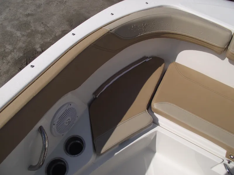 Slide: The Image of 2025 Bayliner Trophy T22SC boat interior with beige seating and cup holders. - 9