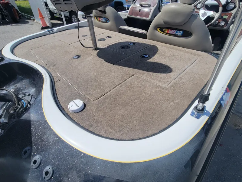 Slide: The Image of 2003 Ranger 521VX NASCAR boat interior with carpeted deck and seating. - 11