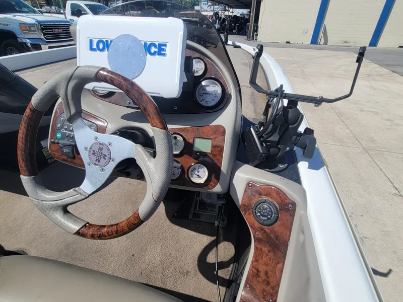Slide: The Image of 2003 Ranger 521VX NASCAR boat dashboard with Lowrance GPS and wood-accented steering wheel. - 12