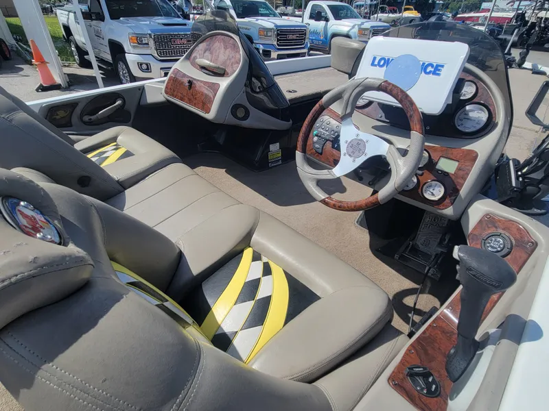 Slide: The Image of 2003 Ranger 521VX NASCAR boat interior with steering wheel, dashboard, and checkered seat design. - 13