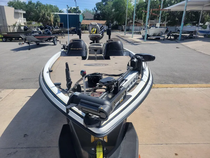 Slide: The Image of 2003 Ranger 521VX NASCAR boat parked outdoors, featuring advanced fishing equipment. - 2